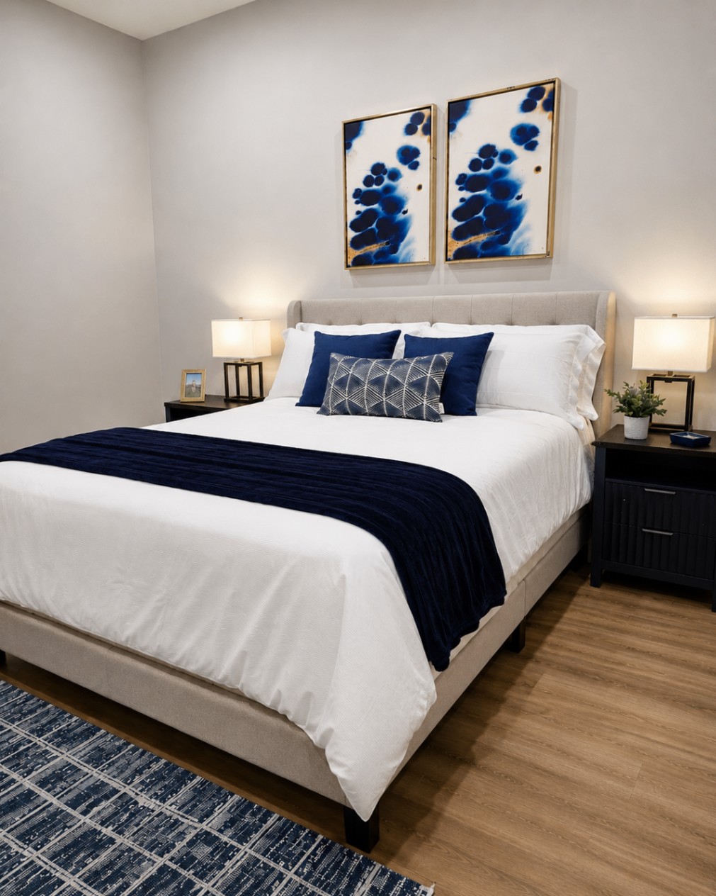 Guest bedroom with queen bed and blue accent art
